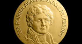 A gold medal with a portrait of john f kennedy.