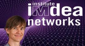 A man standing in front of a purple background with the words institute idea networks.