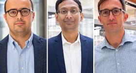 Four men in glasses standing next to each other.