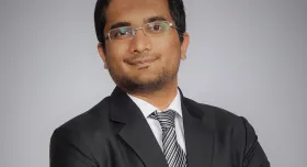 A man in a suit and tie posing for a photo.