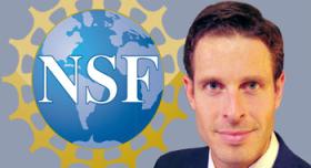 A man in a suit and tie is standing in front of the nsf logo.