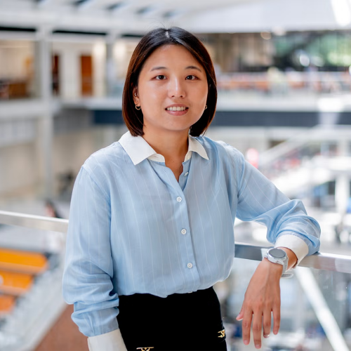 Woman smiling leaning against railing