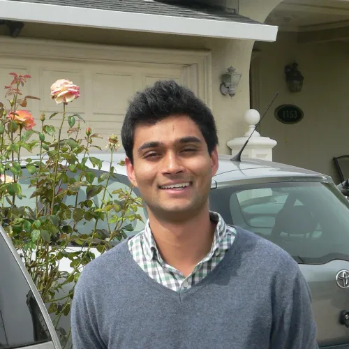 A man standing in front of a house.