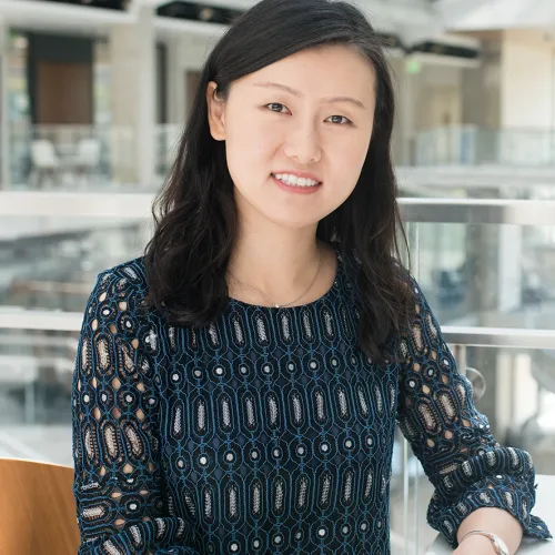 A woman sitting at a table in an office.